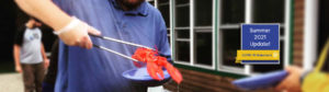 man holding lobster with thongs
